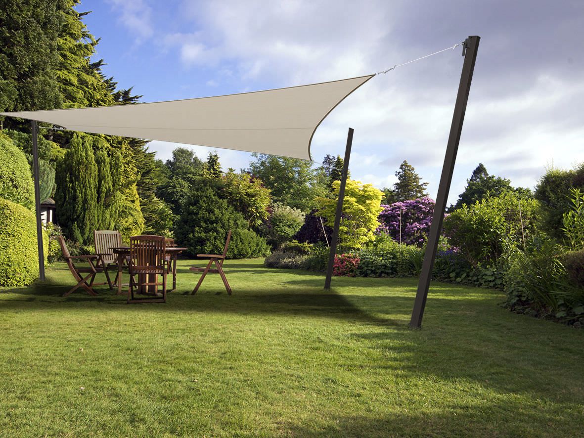 Toldo de vela triangular instalado en un jardín residencial en Chicureo
